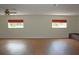 Spacious living room featuring hardwood floors and bright windows with custom red valances at 2543 Chapala Dr, Kissimmee, FL 34746