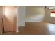 Cozy living room area with wood laminate flooring, natural lighting, and a descending staircase at 2543 Chapala Dr, Kissimmee, FL 34746