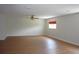 Spacious living room featuring wood laminate flooring, natural lighting, and ceiling fan at 2543 Chapala Dr, Kissimmee, FL 34746