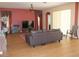 Inviting living room featuring hardwood floors, a leather couch, and neutral wall colors for a cozy ambiance at 2543 Chapala Dr, Kissimmee, FL 34746