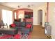 Cozy living room featuring an open layout, hardwood flooring, a comfortable leather couch, and neutral walls at 2543 Chapala Dr, Kissimmee, FL 34746