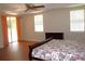 Spacious main bedroom with wooden floors, slider to the outside, tray ceiling and ceiling fan at 2543 Chapala Dr, Kissimmee, FL 34746