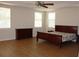 Spacious main bedroom with tray ceiling, ceiling fan, and wood laminate flooring at 2543 Chapala Dr, Kissimmee, FL 34746