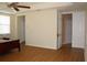Large main bedroom with wood laminate floors, ceiling fan, and access to ensuite at 2543 Chapala Dr, Kissimmee, FL 34746