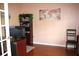 Home office featuring a desk, wooden floors, and a decorative map at 2543 Chapala Dr, Kissimmee, FL 34746
