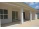 Covered patio with white columns and concrete flooring at 2543 Chapala Dr, Kissimmee, FL 34746