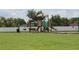 Community playground with play equipment and green grass at 2543 Chapala Dr, Kissimmee, FL 34746