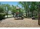 Community playground featuring slides and a playhouse surrounded by mature trees at 2543 Chapala Dr, Kissimmee, FL 34746