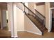 A carpeted staircase with stained wood banister creates an inviting home entry at 2543 Chapala Dr, Kissimmee, FL 34746