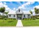 Modern home exterior boasting white metal roof, gray siding, and lush front yard at 2547 Long Pine Ave, Apopka, FL 32712