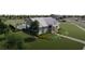Charming exterior view of the home featuring well manicured lawn and landscaping, and community pool area at 2547 Long Pine Ave, Apopka, FL 32712