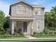 Charming two-story home featuring a covered porch, neutral color palette, manicured lawn, and lush landscaping at 2547 Long Pine Ave, Apopka, FL 32712