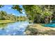 Scenic waterfront view with clear water, kayaks on the shore, and lush greenery at 2547 Long Pine Ave, Apopka, FL 32712