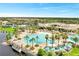 Aerial shot of the community pool, palm trees, tennis courts, and elegant clubhouse at 2578 Cliff Way, St Cloud, FL 34771