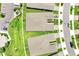 Aerial view showcases the meticulously landscaped yards of a neighborhood with lush green spaces and paved streets at 2578 Cliff Way, St Cloud, FL 34771