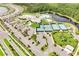 An aerial view showcasing community amenities including a clubhouse, pools, tennis courts, and manicured landscaping at 2578 Cliff Way, St Cloud, FL 34771