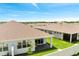 An aerial shot of a private backyard with a covered patio, manicured lawn, and verdant trees in the distance at 2578 Cliff Way, St Cloud, FL 34771