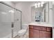 Bathroom featuring a shower with a glass door, toilet, and a large sink at 2578 Cliff Way, St Cloud, FL 34771