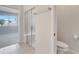 Bright bathroom featuring shower with glass door, toilet, and neutral paint at 2578 Cliff Way, St Cloud, FL 34771