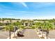 Exterior shot of clubhouse entrance, framed by palm trees and a meticulously maintained parking area at 2578 Cliff Way, St Cloud, FL 34771