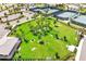 Aerial shot of a dog park featuring agility equipment, mature palm trees, and lush green grass at 2578 Cliff Way, St Cloud, FL 34771