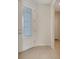 Bright foyer featuring a decorative glass front door, neutral walls, and ceramic tile flooring throughout at 2578 Cliff Way, St Cloud, FL 34771