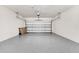 Bright garage with garage door closed, epoxy flooring, white walls, and space for two cars at 2578 Cliff Way, St Cloud, FL 34771