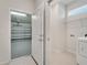Bright laundry room connecting to a garage featuring epoxy floor at 2578 Cliff Way, St Cloud, FL 34771
