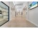 Bright hallway with neutral tile flooring and architectural lighting, leading to various rooms and common areas at 2578 Cliff Way, St Cloud, FL 34771
