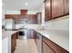 Well-lit kitchen boasts stainless steel appliances, granite countertops, and dark wood cabinetry at 2578 Cliff Way, St Cloud, FL 34771
