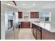 Contemporary kitchen with stainless steel appliances, white countertops, dark wood cabinets, and ample natural light at 2578 Cliff Way, St Cloud, FL 34771