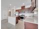 Modern kitchen featuring an island, stainless steel appliances, dark wood cabinets, and recessed lighting at 2578 Cliff Way, St Cloud, FL 34771