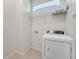 Laundry room featuring a washer, dryer, and a wire shelf at 2578 Cliff Way, St Cloud, FL 34771