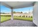Covered patio area with brick pavers, looking out to the manicured lawn and landscaped backyard at 2578 Cliff Way, St Cloud, FL 34771