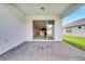 Covered patio with brick pavers and an open view of the home's bright, modern interior at 2578 Cliff Way, St Cloud, FL 34771