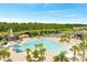 Resort-style pool with mature palm trees, lounge chairs, and scenic lake backdrop at 2578 Cliff Way, St Cloud, FL 34771