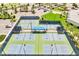 Aerial view of pristine tennis courts with well-maintained green and blue playing surfaces, surrounded by lush landscaping at 2578 Cliff Way, St Cloud, FL 34771