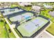 Aerial view of professionally designed tennis courts with lush landscaping and sidewalks at 2578 Cliff Way, St Cloud, FL 34771