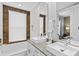 Modern bathroom featuring a soaking tub and double sink vanity at 2630 Sunrise Shores Dr, Kissimmee, FL 34747