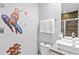 Spiderman themed bathroom with granite counters, glass shower and cartoon decor at 2630 Sunrise Shores Dr, Kissimmee, FL 34747