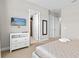 Bedroom features a TV, closet, and doorways to other rooms at 2630 Sunrise Shores Dr, Kissimmee, FL 34747