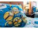 A bedroom with Minions themed pillow and bedding, desk lamp on the nightstand at 2630 Sunrise Shores Dr, Kissimmee, FL 34747