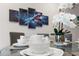 Elegant dining area with modern table setting, floral centerpiece, and stylish superhero wall art at 2630 Sunrise Shores Dr, Kissimmee, FL 34747