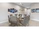 Dining area with a glass table, seating for eight, and contemporary decor at 2630 Sunrise Shores Dr, Kissimmee, FL 34747