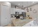 Modern kitchen with a granite island, stainless steel appliances, and ample cabinet space at 2630 Sunrise Shores Dr, Kissimmee, FL 34747
