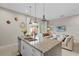 Bright open kitchen with granite countertops, island seating, and integrated living space at 2630 Sunrise Shores Dr, Kissimmee, FL 34747