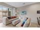 Cozy living room with comfortable seating, sliding glass doors, and neutral décor at 2630 Sunrise Shores Dr, Kissimmee, FL 34747