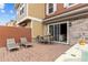 Back patio featuring a dining area, lounge chairs, outdoor hot tub, and sliding glass doors at 2630 Sunrise Shores Dr, Kissimmee, FL 34747