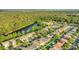 Beautiful aerial view of a neighborhood near a serene lake, surrounded by lush greenery and mature trees at 2657 Bullion Loop, Sanford, FL 32771