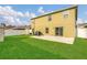 View of the backyard with a well-maintained lawn and a concrete patio, perfect for outdoor entertaining at 2657 Bullion Loop, Sanford, FL 32771